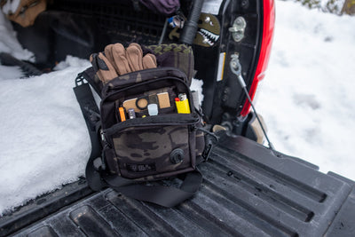 Sportsman open on a tailgate with gloves
